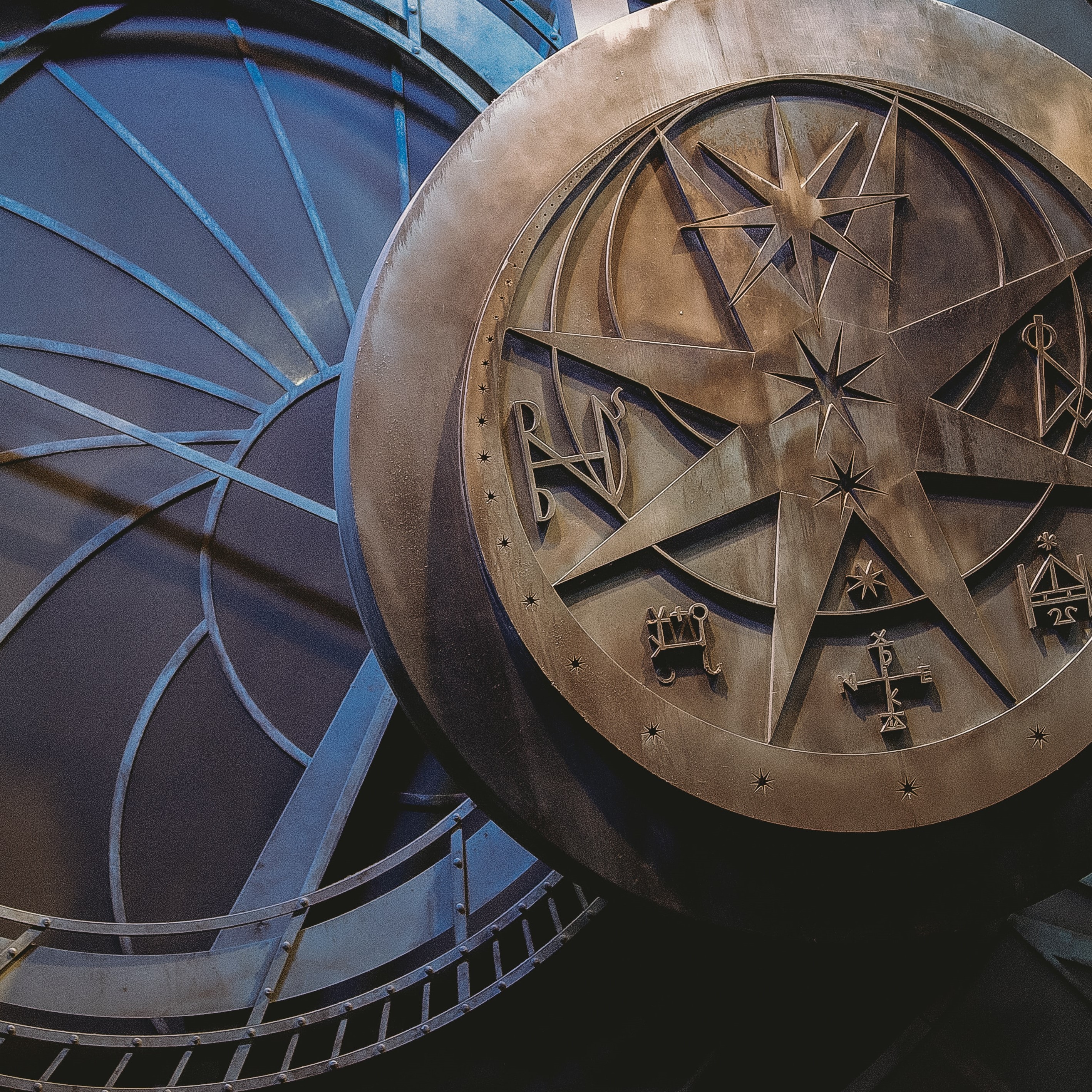 A circular object with multiple sets of strange symbols hovers over some other concentric circles. Credit to Rhii Photography</a> on Unsplash.